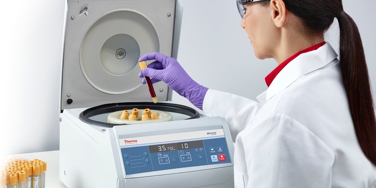 Laboratory professional using a centrifuge
